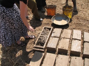 Molding brick on a flattened area of ground. Tanzania brickmaking courtesy of Dr. Young 